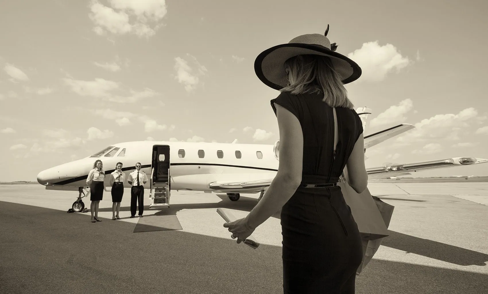 A guest boarding a private jet, crew waiting on the apron
