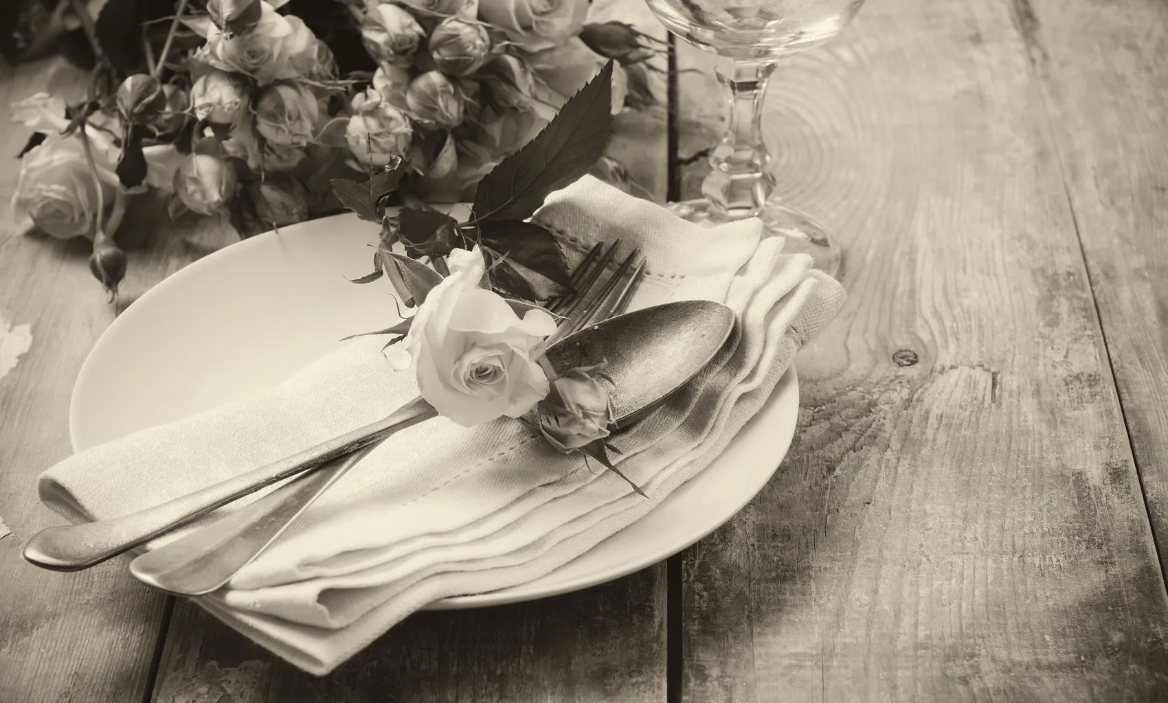 An elegant table setting dressed with roses